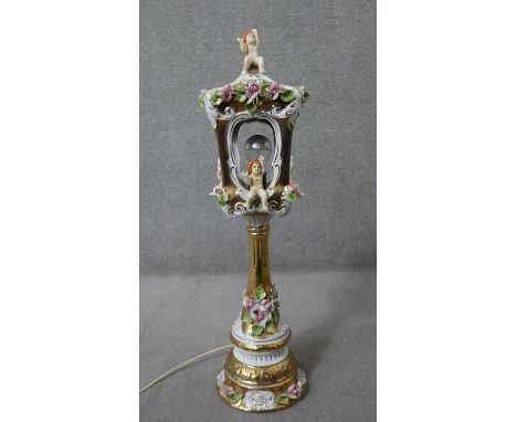 A large vintage Capodimonte style ceramic hand painted gilded lantern form table lamp with floral and putti decoration. H.80 