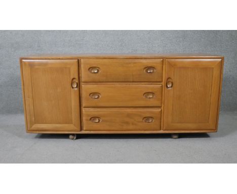 A vintage Ercol light elm sideboard, model 455, fitted with sliding cutlery drawer. H.68 W.155 D.46cm 