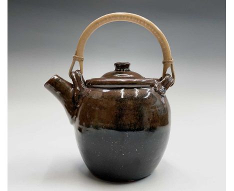 Trevor CORSER (1938-2015)A tenmoku glaze teapot with swing bamboo handleImpressed makers marksHeight (including handle) 25.5c