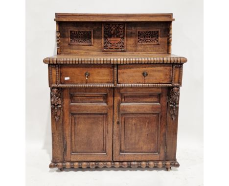 19th century oak chiffonier, the back with a single shelf and blind fretwork carved panels, supported by two pairs of turned 