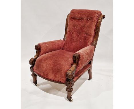 A Victorian walnut framed Aesthetic Movement armchair, the frame carved with various motifs, button back upholstered in pink 