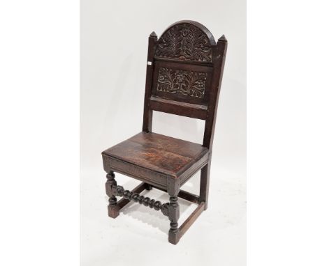 17th/18th century oak backstool the back carved with stylised flowers and leaves and with pyramidal ears and solid seat and r