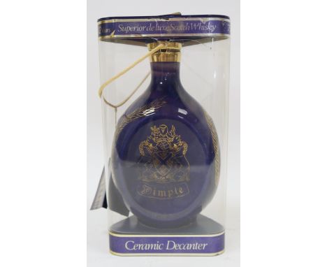 A blue ceramic decanter of John Haig's Dimple de Luxe scotch whisky in original perspex triangular case