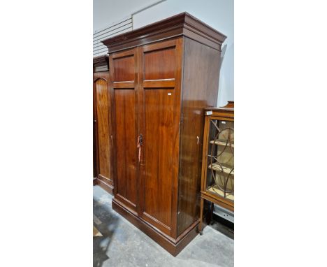 Large late Victorian mahogany two-door wardrobe containing a clothes rail and numerous coat hooks, 230cm high x 122cm wide x 