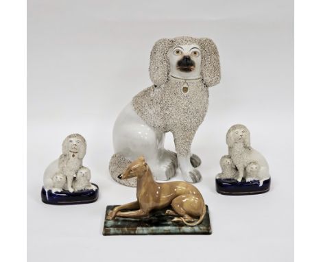 In the manner of Minton a majolica model of a brindle greyhound 12cm high, a late 19th century Staffordshire seated poodle wi