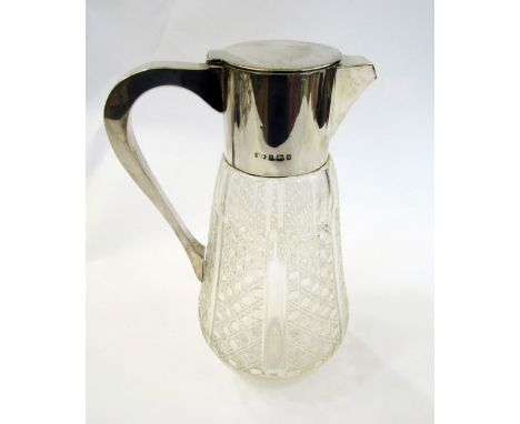Edwardian silver mounted cut class carafe having flat flush fitting lid, the tapered body with octagonal graduated cutting pa