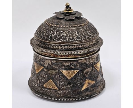Indian white metal caddy or box,&nbsp;of cylindrical form with profuse intricate repousse decoration, the lift off domed lid 
