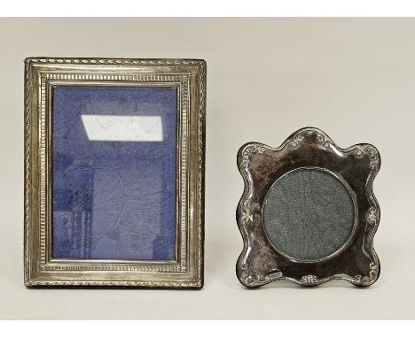 Two silver photograph frames, the first rectangular with an easel back, Sheffield 1989 R Carr, 23cm high the other shaped wit
