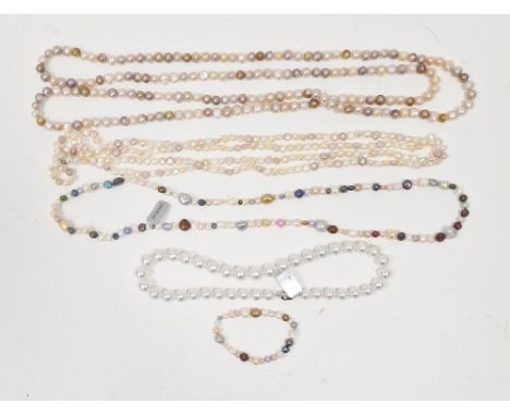 Two long strings of pink, cream and other coloured cultured pearls, a string of coloured cultured pearls, a string of white l
