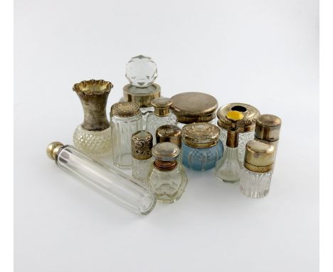 A collection of silver-mounted glass toilet jars, various dates and makers, comprising: one with a yellow enamel cover, one w