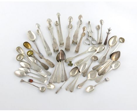 A mixed lot of silver flatware, various dates and makers, comprising: a pair of 18th century sugar nips, eight pairs of sugar