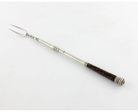 λ An 18th century silver toasting fork, unmarked circa 1780, the two-pronged fork with scroll supports, tapering stem with a 