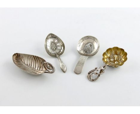 A small collection of four antique silver caddy spoons, comprising: one of heart form, the bowl with pierced and engraved dec