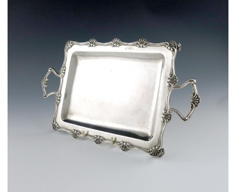 An Edwardian two-handled silver tray, by William Hutton and Sons, Sheffield 1909, rectangular form, shell and scroll border, 