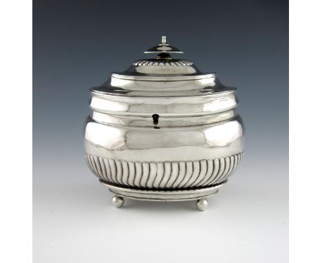 A George IV silver tea caddy, by William Bateman, London 1824, oblong bellied form, part-fluted decoration, flush hinged cove