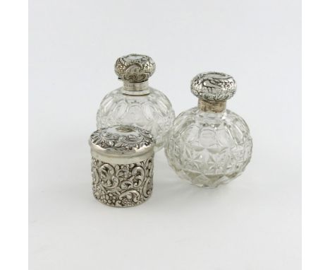 A pair of Edwardian silver-mounted scent bottles, by William Hutton and Sons, Birmingham 1903/4, globular form, the hinged co