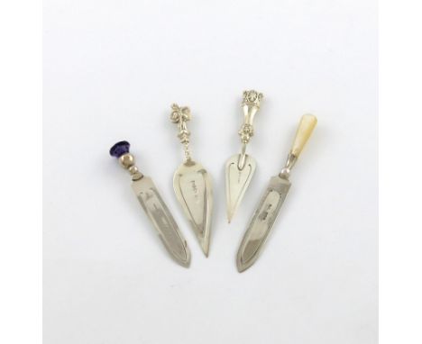 A small collection of four silver page markers, various dates and makers, comprising: one with a purple thistle terminal, one