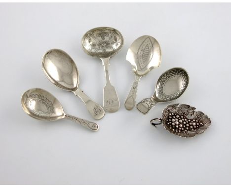 A collection of six antique silver caddy spoons, comprising a George III one, of leaf form, embossed with a bunch of grapes, 