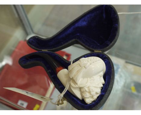 A Meerschaum pipe, unused, the bowl carved as a Turk's head and plastic tortoise-shell style stem, in fitted case.
