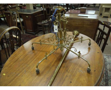 A late 19th Century brass five-branch centre ceiling light fitting converted from gas to electricity, complete with ceiling f