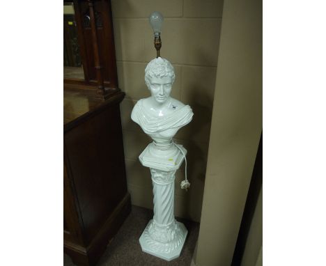 A modern table lamp in the form of a white ceramic bust standing on a corinthian style column.