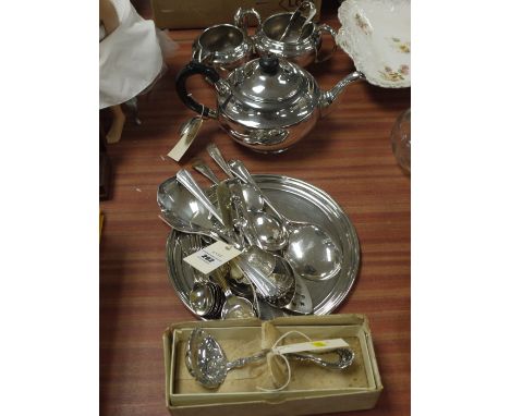 A quantity of silver plated ware, including: a three-piece tea service; cutlery; a tray; and a decorative ladle.
