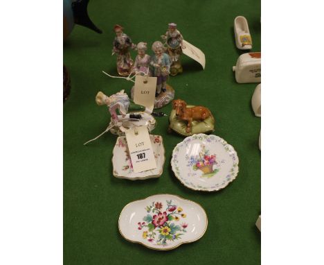 A Royal Crown Derby figurine: "The First Attempt", by Edward Drew; three Continental figurines; a dog on cushion; together wi