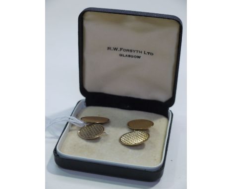 A pair of 9ct. yellow gold cufflinks with engine turned design.