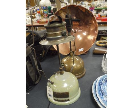 A Tilley radiator; a polished copper heat reflector and brass reservoir; together with a Model EX100 tilley lamp with hanging