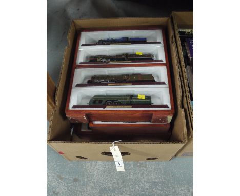 Three cases of model railway engines, four engines in each case.