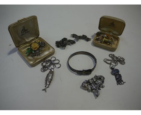 A large quantity of silver and other costume jewellery, including: enamelled and marcasite brooches; a buckle pattern bangle;