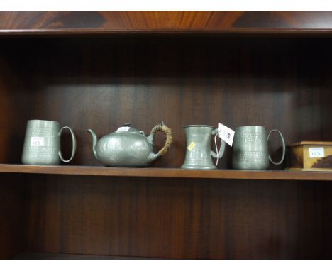 Three beaten pewter tankards; a teapot; and a wooden box.