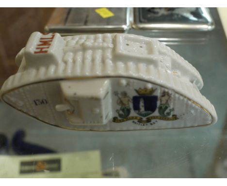 A Carlton china crested ware pepperette in the form of a First World War tank, inscribed 'HMLS (His Majesty's Land Ships)', a