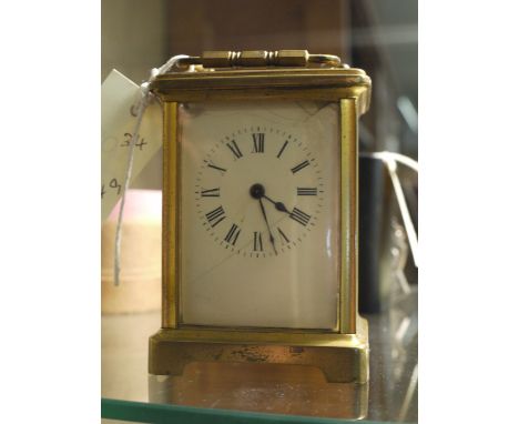 A French lacquered brass carriage clock, with white enamel roman dial and lever arch escapement.