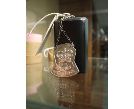 A silver 'Sherry' decanter label commemorating the Silver Jubilee of Queen Elizabeth II.