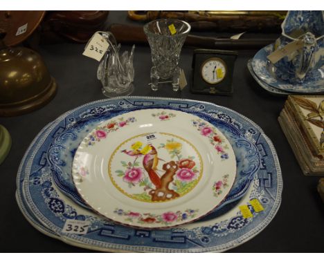 Two 'Willow' pattern blue and white meat plates; two other plates; a travelling clock; and two pieces of glass.