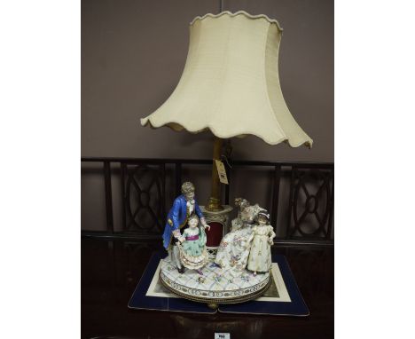 An imposing Meissen table lamp of a figure group, with floral decoration and ormolu mounts.