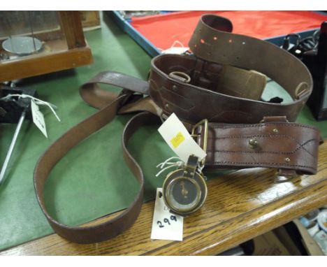 A First World War brass hand bearing compass; and two leather belts.