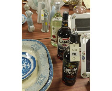 Two bottles of Lambs Navy Rum and Captain Morgan Black Label Rum; together with a bottle of Light Dry Bacardi Rum.