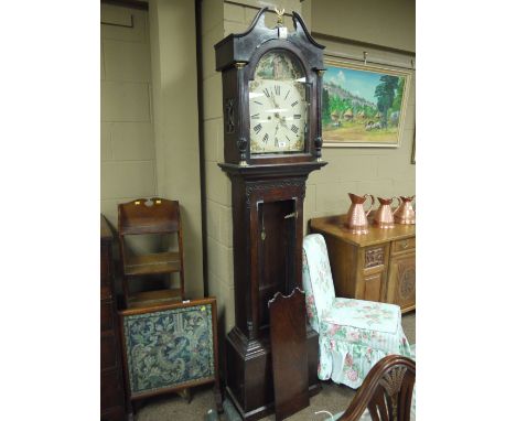 An antique long case clock in mahogany case with broken swan neck pediment in brass eagle finial, the arched panel glazed doo