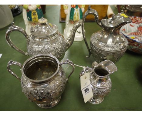 A four-piece silver plated tea service with embossed decoration.