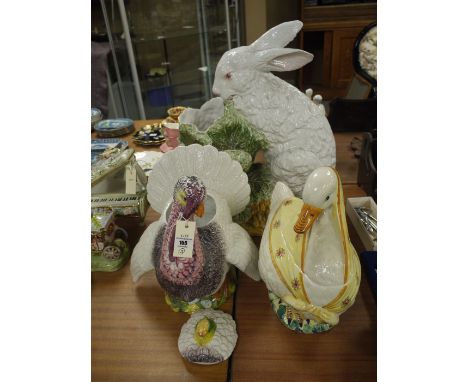 A large rabbit planter; a duck and a swan.