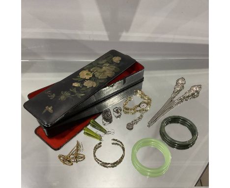 A Japanned lacquer glove box containing various costume jewellery, including jade bangles, glove stretchers, rings etc