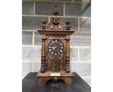 An Austrian carved walnut trumpet table clock,  clock movement signed GHS, Gordian Hettich Sohn, Furtwangen, 73cm high