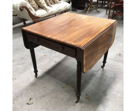 A Regency mahogany and crossbanded Pembroke table, fitted single drawer and dummy drawer on rope twist and ring turned suppor