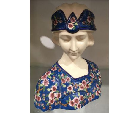 An Art Deco Longwy style ceramic bust, enamelled prunus and turquoise ground