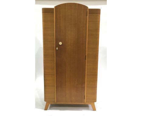 An Art Deco wardrobe, single door with shelf and hanging interior, on splayed supports 176cm high, 89cm wide