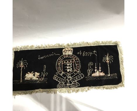A Second World War era Royal Corps Army Ordinance embroidery, with coat of arms and depicting Egyptian scenes, 70cm x 28cm