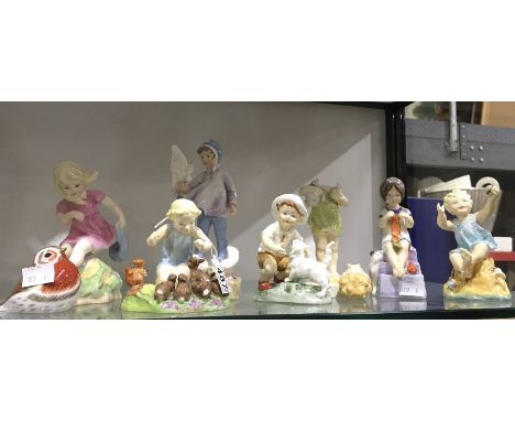 A collection of seven Royal Worcester Doughty figures including months of the year and a Crown Derby Royal Robin gold stopper