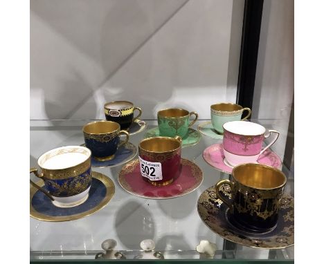 Eight Royal Worcester cabinet coffee cups and saucers including raised gilt and jewelled examples